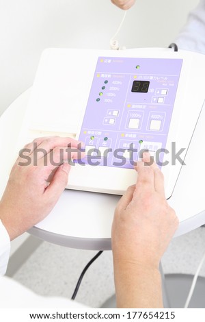 Hand of a doctor conducting hearing test