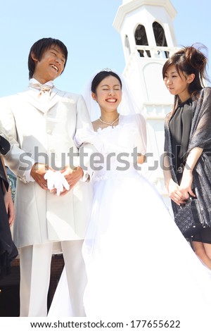 Japanese Bride and groom being blessed by friend