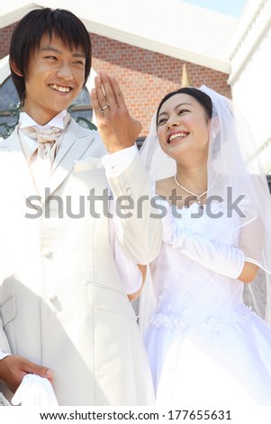 Japanese Groom to show the wedding ring to a friend