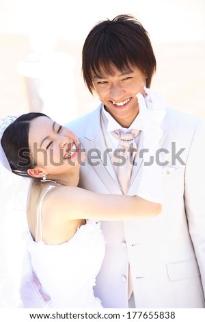 Bride pinching the cheek of the groom