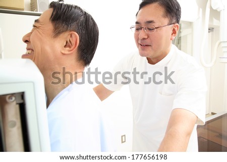 Japanese Technician explaining X-ray to patient
