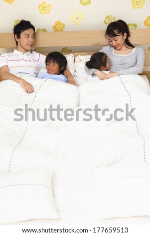 Japanese parents putting a child to sleep