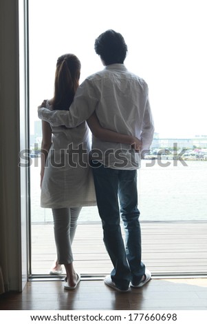 Rear View of a Japanese couple that look out at the window