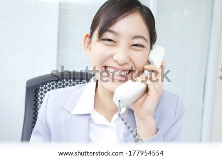 Japanese businesswoman having a telephone conversation