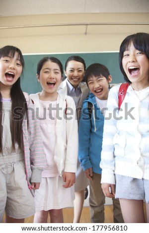 Female teacher and Primary Japanese boy and Japanese girl with a smile