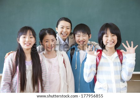 Female Japanese teacher and Primary Japanese boy and Japanese girl with a smile