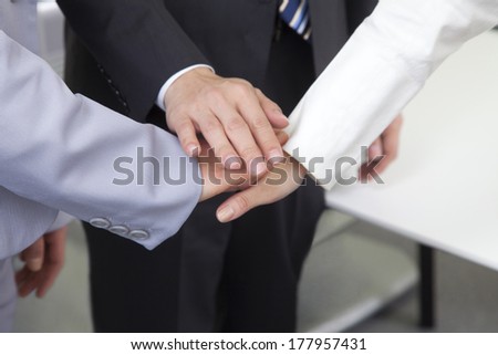 Three businessman hands together