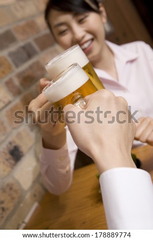 Office Lady toasting in a pub with colleagues
