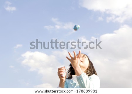 Japanese girl playing a game with marbles
