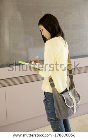 Japanese girl looking at bulletin board