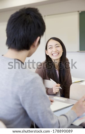 Japanese university students talking in a classroom