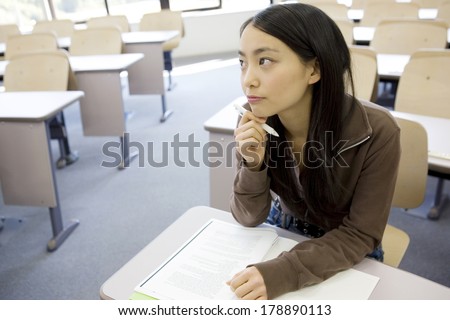 Japanese Student thinking while writing