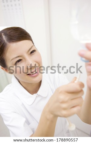 Japanese Nurse performs a visual acuity test