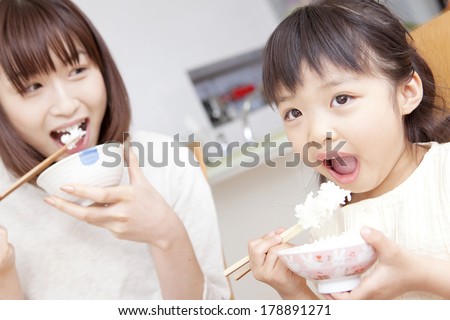 Japanese mother and daughter eating rice