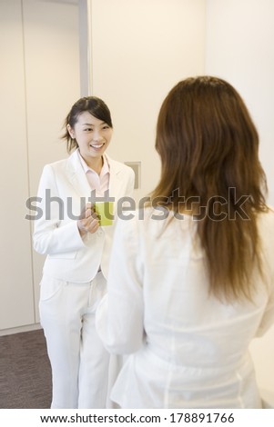 Japanese businesswoman talking in a supply room