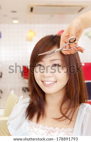 Japanese woman having hair cut in salon