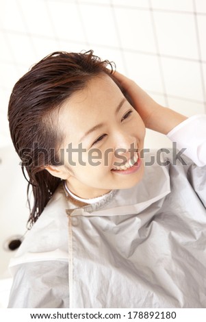 Japanese woman having hair washed in the hair salon