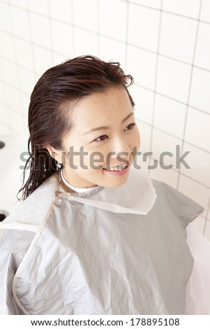 Japanese woman having hair washed in the hair salon