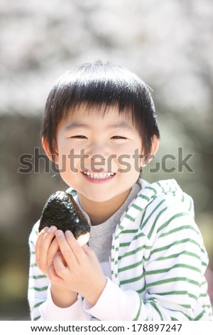 Japanese boy eating rice balls