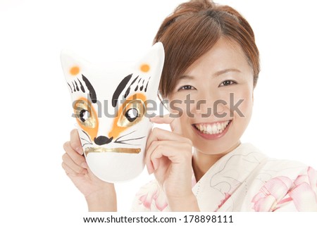 Japanese woman in yukata with the mask of the fox