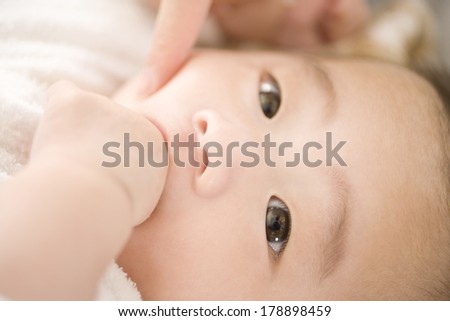 Japanese Baby biting finger in mouth