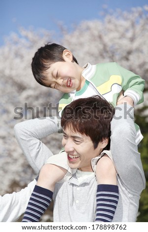 Japanese Father gives a son a ride on his shoulders