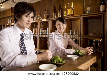 Business lady and business Japanese man waiting for a drink at the pub