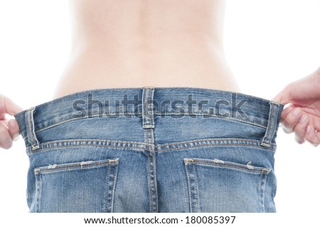 Rear view of Japanese woman demonstrating that jeans do not fit because they are too large