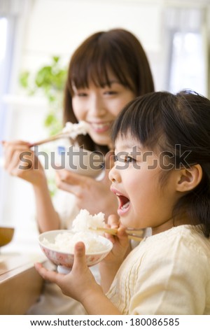 Japanese mother and daughter eating rice