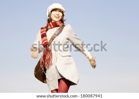 Japanese woman jumping while listening to music