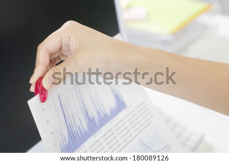 Hand of person putting a paperclip on the documents