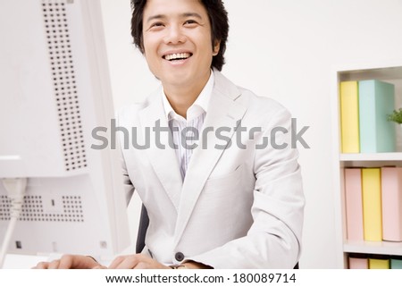 Businessman talking to someone while using al computer