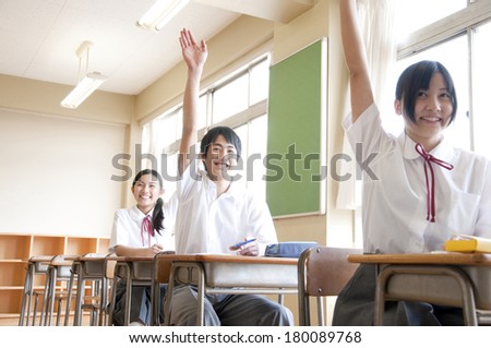 Three junior high students with a show of hands