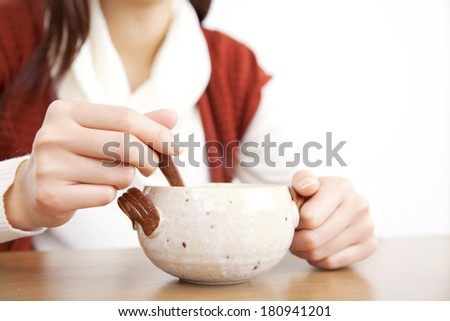 Hand of a Japanese woman stirring the soup