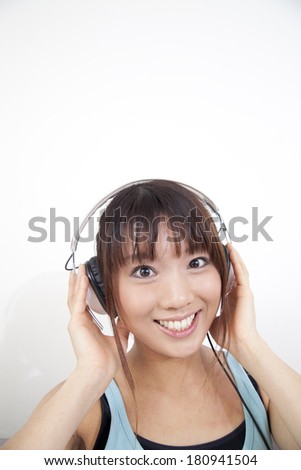 Japanese woman listening to music with headphones