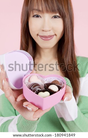 Japanese woman to open a box of chocolate