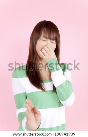 Japanese woman pinch the nose