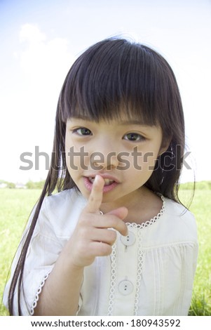 Girls making a index finger in front of mouth