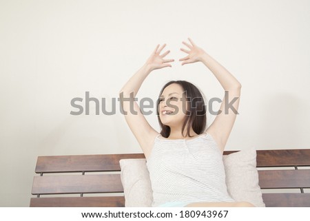 Japanese woman stretching in bed