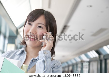 A Japanese student talking on her smart phone,