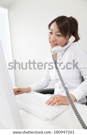 Japanese office lady talking on the phone,