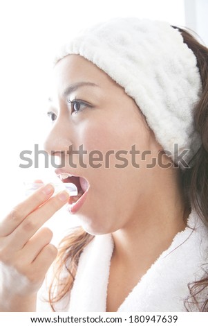 Japanese woman putting on a mouth piece,