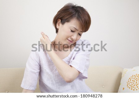 Japanese woman suffering from stiff neck,