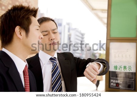 Japanese businessmen waiting for a bus