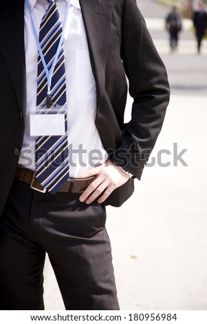 Japanese Businessman holding his waist with his hands