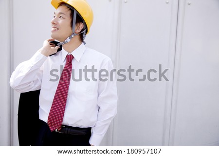 Japanese Businessman holding a jacket
