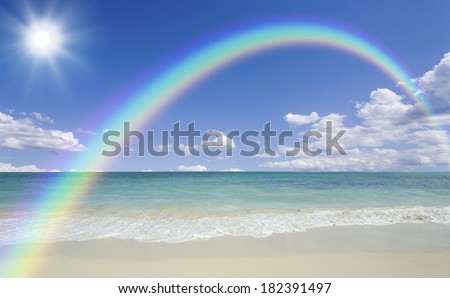 Rainbow and the sun and the clouds and the waves and beach