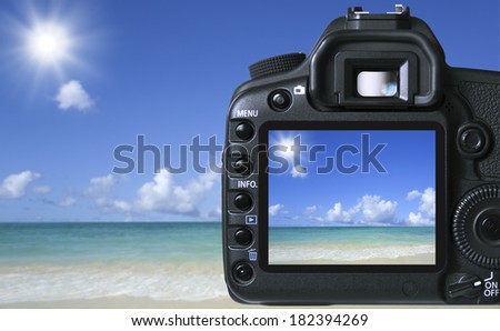 Digital camera taking picture of the sun over the beach, Hawaii