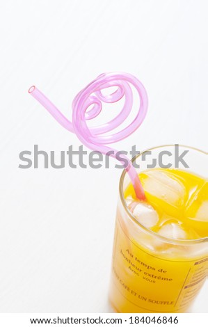 Orange juice and straw round and round