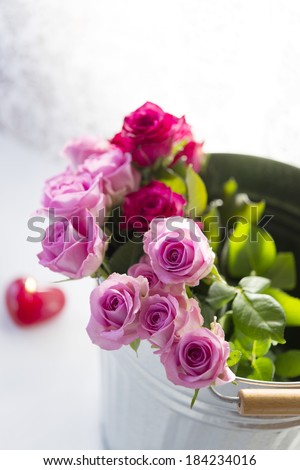 Bouquet of roses in a bucket.